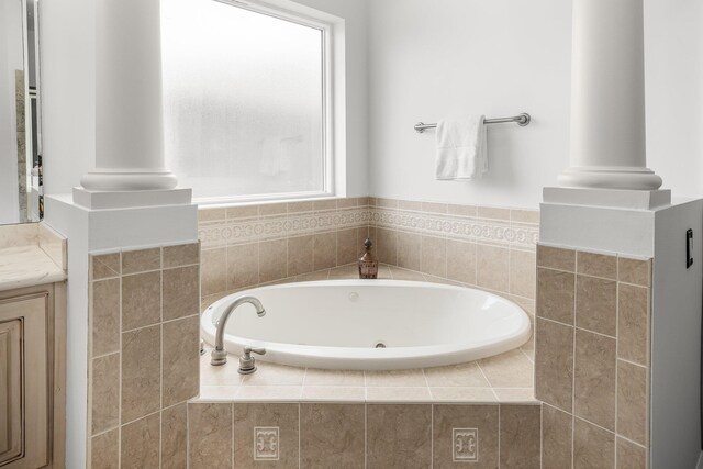 203 Landings Dr, Lynn Haven, FL 32444 - full bathroom featuring a jetted tub, decorative columns, and vanity