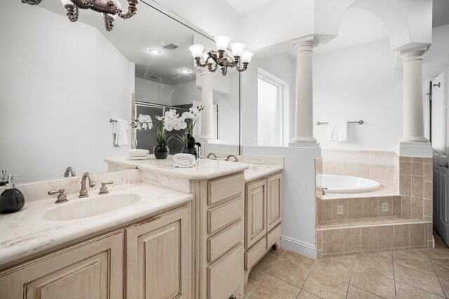 203 Landings Dr, Lynn Haven, FL 32444 - full bath featuring decorative columns, two vanities, a bath, and tile patterned flooring