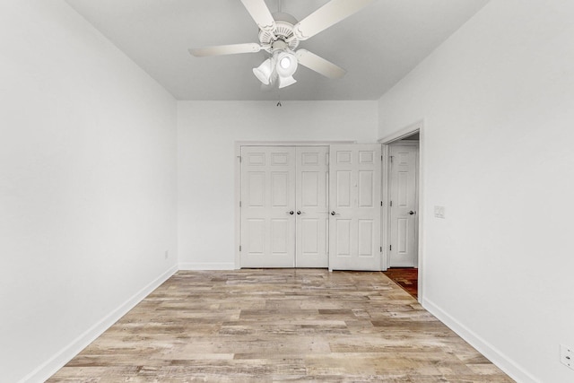 203 Landings Dr, Lynn Haven, FL 32444 - unfurnished bedroom featuring light wood-style floors, ceiling fan, baseboards, and a closet