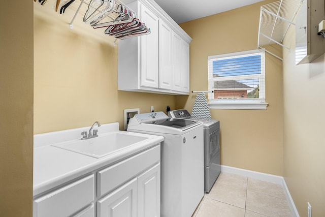 203 Landings Dr, Lynn Haven, FL 32444 - laundry area with cabinet space, washing machine and dryer, baseboards, and light tile patterned floors