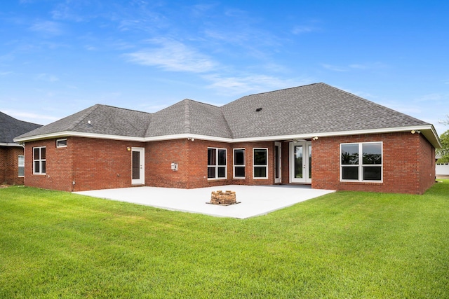203 Landings Dr, Lynn Haven, FL 32444 - back of property featuring a shingled roof, a patio area, a yard, and brick siding