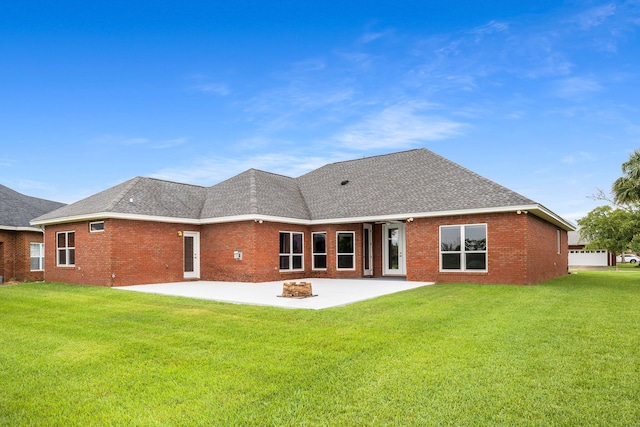 203 Landings Dr, Lynn Haven, FL 32444 - back of property with a patio area, brick siding, a lawn, an outdoor fire pit, and a shingled roof