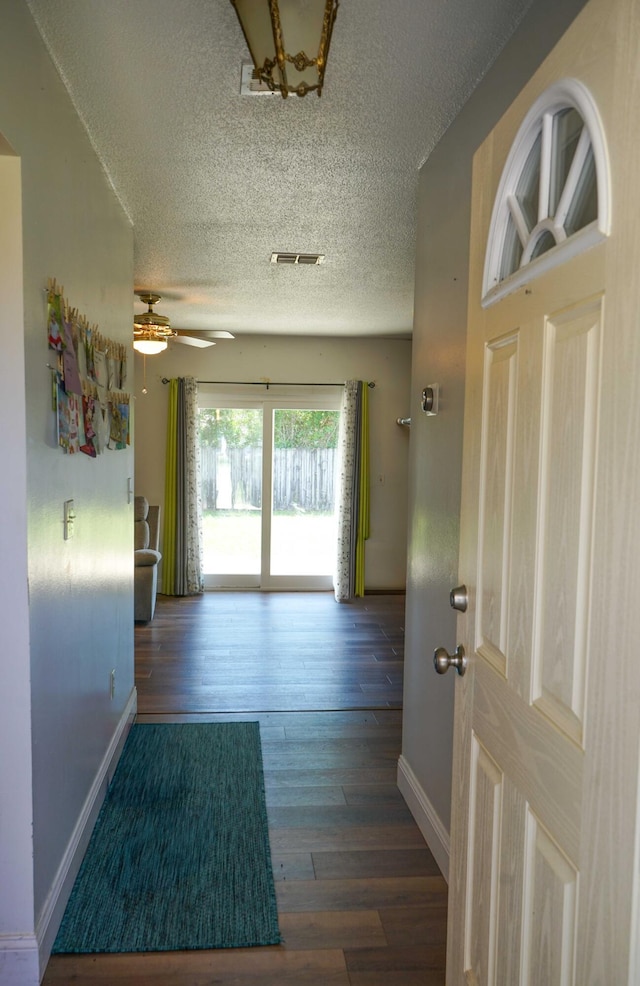 74 8th St, Shalimar, FL 32579 - hallway with a textured ceiling and wood finished floors