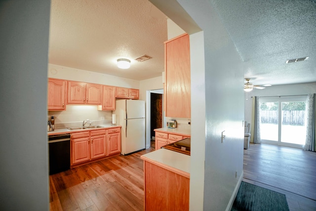 74 8th St, Shalimar, FL 32579 - kitchen with dishwasher, freestanding refrigerator, a textured ceiling, light brown cabinets, and light wood-style floors
