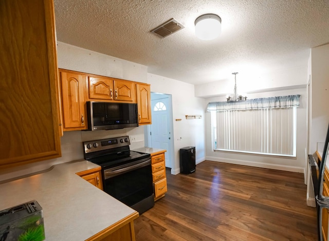 74 8th St, Shalimar, FL 32579 - kitchen featuring black microwave, range with electric cooktop, light countertops, dark wood-type flooring, and a textured ceiling