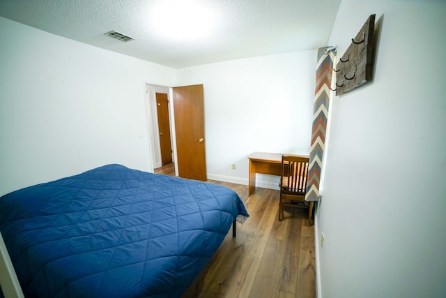 74 8th St, Shalimar, FL 32579 - bedroom featuring wood finished floors and a textured ceiling