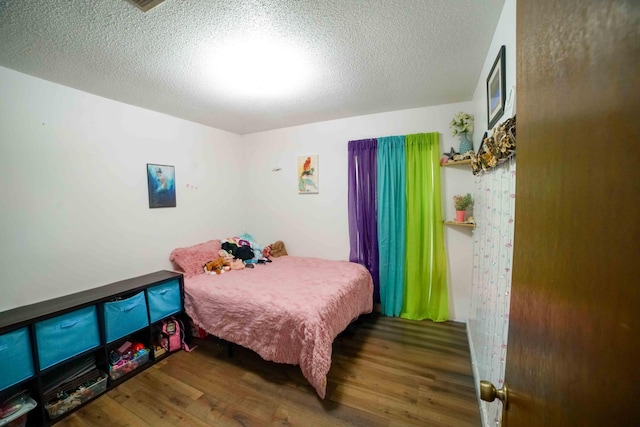 74 8th St, Shalimar, FL 32579 - bedroom with wood finished floors and a textured ceiling