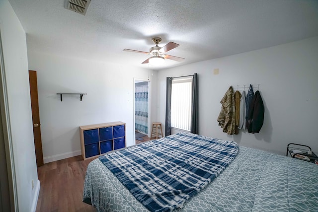 74 8th St, Shalimar, FL 32579 - bedroom featuring wood finished floors, a textured ceiling, and a ceiling fan