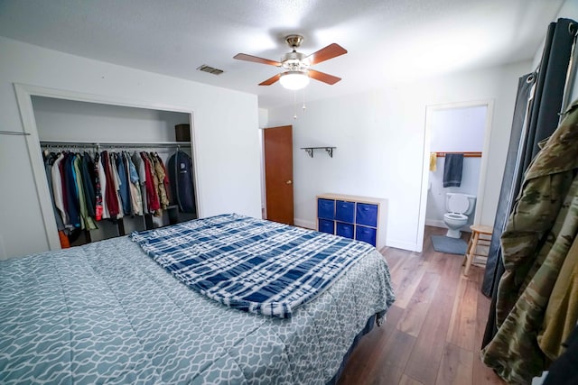 74 8th St, Shalimar, FL 32579 - bedroom with wood finished floors, a closet, a ceiling fan, and ensuite bath