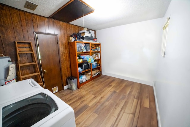 74 8th St, Shalimar, FL 32579 - laundry area with washer / dryer, attic access, water heater, wood finished floors, and wooden walls