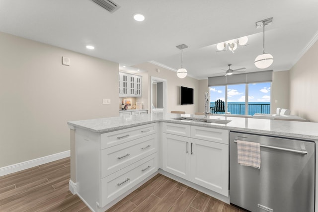 17281 Front Beach Rd Unit 1206, Panama City Beach, FL 32413 - kitchen with dishwasher, crown molding, wood finished floors, white cabinetry, and decorative light fixtures