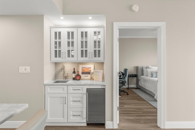 17281 Front Beach Rd Unit 1206, Panama City Beach, FL 32413 - indoor wet bar with stainless steel refrigerator, backsplash, wood finished floors, and recessed lighting