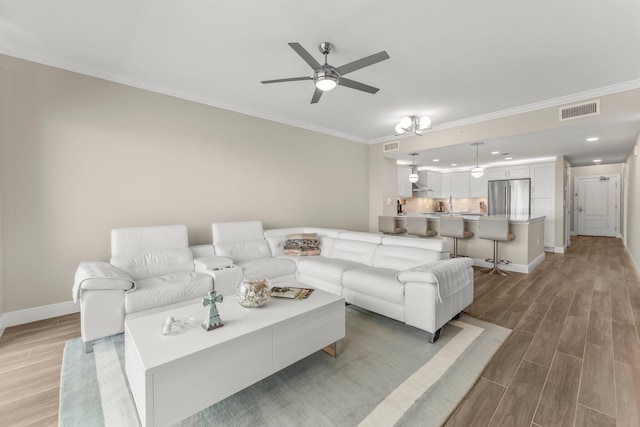 17281 Front Beach Rd Unit 1206, Panama City Beach, FL 32413 - living room featuring light wood finished floors, ornamental molding, a ceiling fan, and recessed lighting