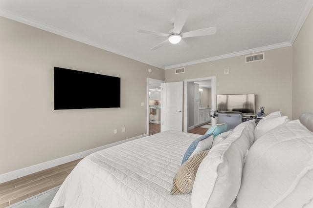 17281 Front Beach Rd Unit 1206, Panama City Beach, FL 32413 - bedroom with wood finished floors, ornamental molding, a ceiling fan, and connected bathroom