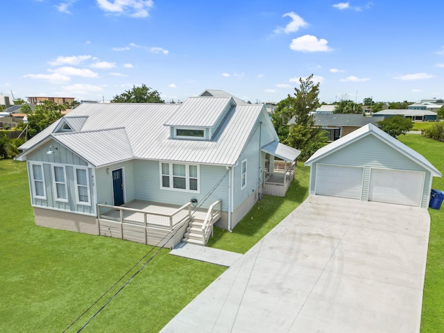 413 Colorado Dr, Mexico Beach, FL 32456 - view of front facade with a detached garage, a front lawn, metal roof, and an outbuilding