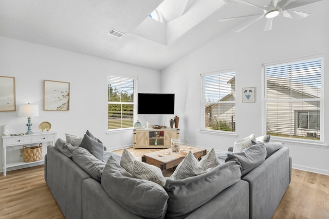 413 Colorado Dr, Mexico Beach, FL 32456 - living area with vaulted ceiling, healthy amount of natural light, light wood-style flooring, ceiling fan, and a skylight