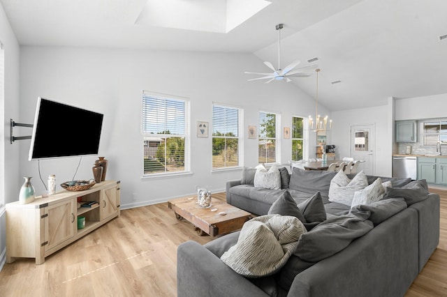 413 Colorado Dr, Mexico Beach, FL 32456 - living area with a skylight, ceiling fan, light wood-style floors, a chandelier, and high vaulted ceiling