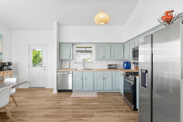 413 Colorado Dr, Mexico Beach, FL 32456 - kitchen featuring appliances with stainless steel finishes, a sink, butcher block countertops, and plenty of natural light