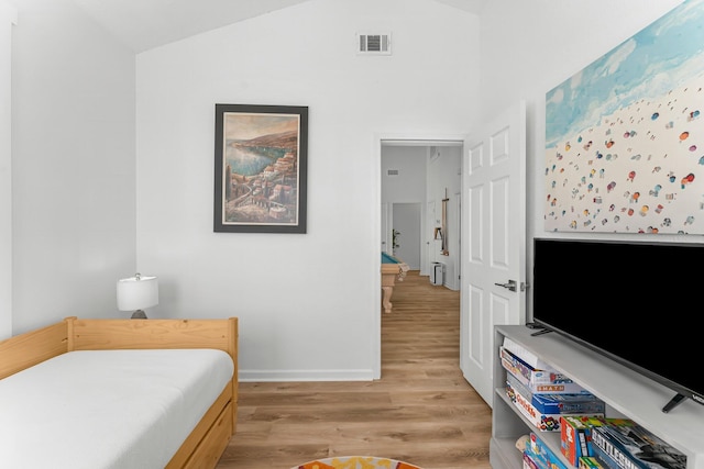 413 Colorado Dr, Mexico Beach, FL 32456 - bedroom featuring light wood-style floors, vaulted ceiling, and baseboards