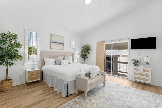 413 Colorado Dr, Mexico Beach, FL 32456 - bedroom featuring vaulted ceiling, light wood-style floors, and baseboards