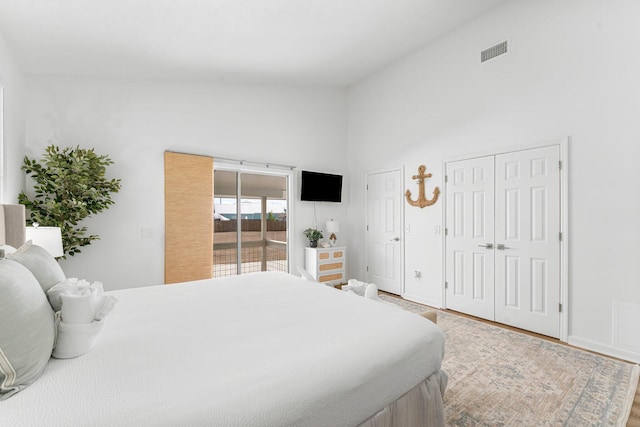 413 Colorado Dr, Mexico Beach, FL 32456 - bedroom with two closets, wood finished floors, high vaulted ceiling, and access to exterior
