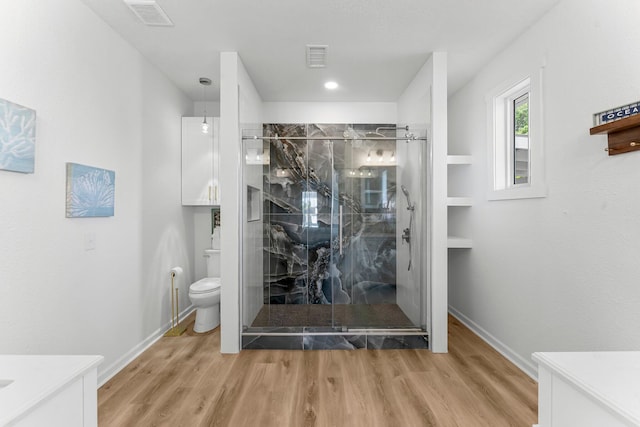 413 Colorado Dr, Mexico Beach, FL 32456 - bathroom featuring vanity, a marble finish shower, toilet, wood finished floors, and baseboards