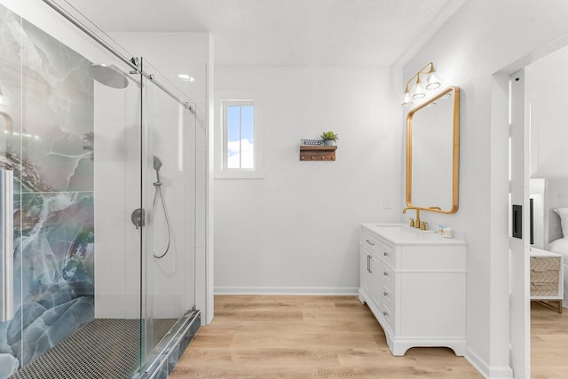 413 Colorado Dr, Mexico Beach, FL 32456 - bathroom with vanity, a stall shower, wood finished floors, and baseboards