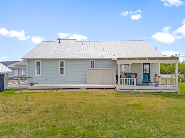413 Colorado Dr, Mexico Beach, FL 32456 - rear view of property with a lawn, metal roof, and a deck