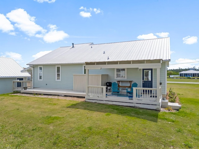 413 Colorado Dr, Mexico Beach, FL 32456 - back of property with a lawn, metal roof, and a deck