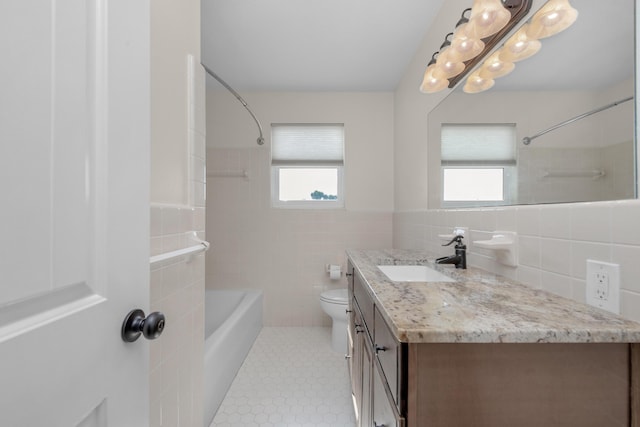 411-A Cobia Ave, Fort Walton Beach, FL 32548 - bathroom featuring tile walls, vanity,  shower combination, tile patterned floors, and a wainscoted wall