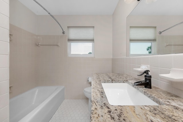 411-A Cobia Ave, Fort Walton Beach, FL 32548 - bathroom with tile walls, healthy amount of natural light, shower / washtub combination, vanity, and wainscoting