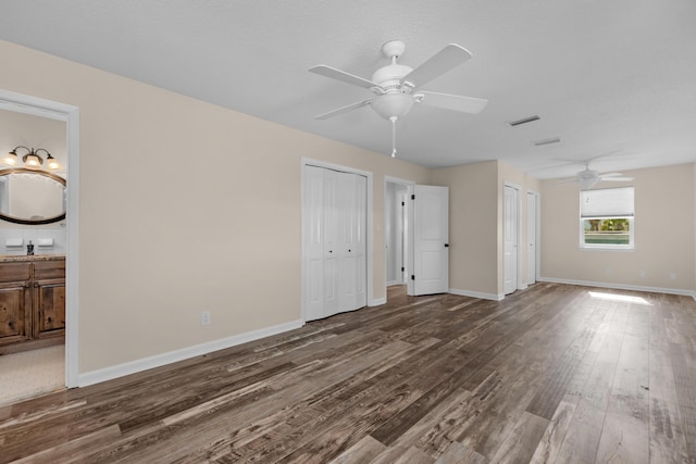 411-A Cobia Ave, Fort Walton Beach, FL 32548 - unfurnished bedroom featuring wood finished floors, two closets, connected bathroom, and ceiling fan