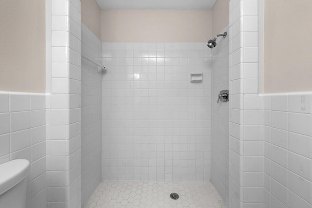 411-A Cobia Ave, Fort Walton Beach, FL 32548 - bathroom featuring tile walls, a shower stall, and a wainscoted wall