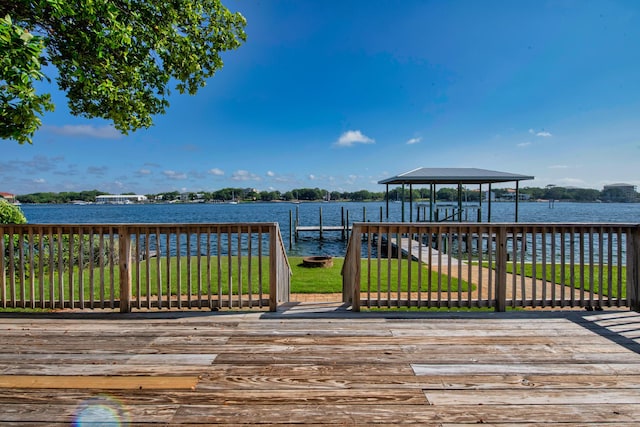 411-A Cobia Ave, Fort Walton Beach, FL 32548 - deck featuring a water view, a lawn, and a boat dock