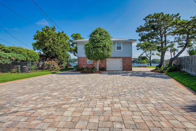 411-A Cobia Ave, Fort Walton Beach, FL 32548 - view of front of home featuring decorative driveway, an attached garage, and brick siding
