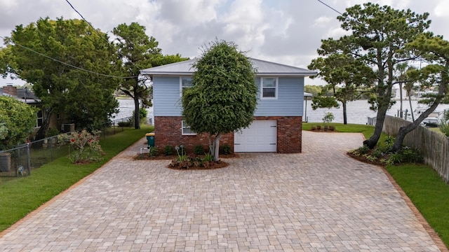 411-A Cobia Ave, Fort Walton Beach, FL 32548 - view of front of house with brick siding, decorative driveway, an attached garage, and a metal roof