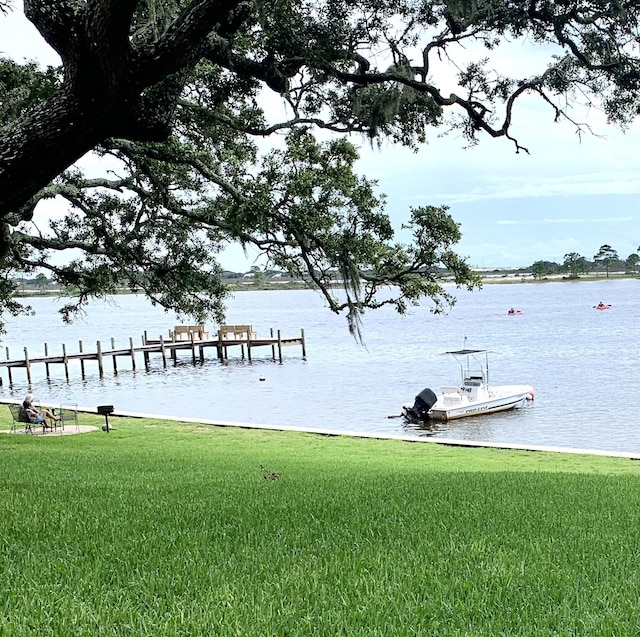 209 W Miracle Strip Pkwy Unit H 103, Mary Esther, FL 32569 - dock featuring a lawn and a water view