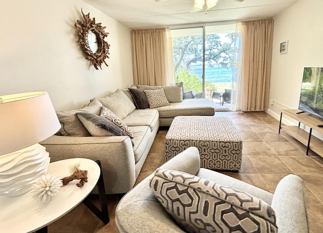 209 W Miracle Strip Pkwy Unit H 103, Mary Esther, FL 32569 - living room featuring a wall of windows, baseboards, and a ceiling fan