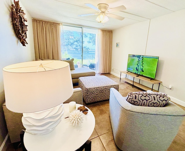209 W Miracle Strip Pkwy Unit H 103, Mary Esther, FL 32569 - tiled living room featuring a ceiling fan, baseboards, and expansive windows