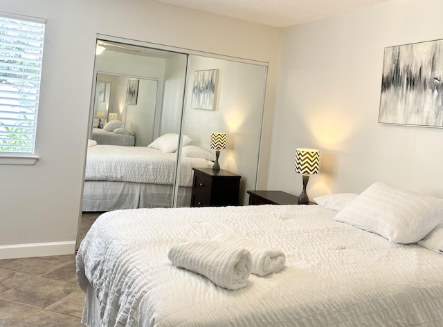 209 W Miracle Strip Pkwy Unit H 103, Mary Esther, FL 32569 - bedroom with a closet, multiple windows, and baseboards