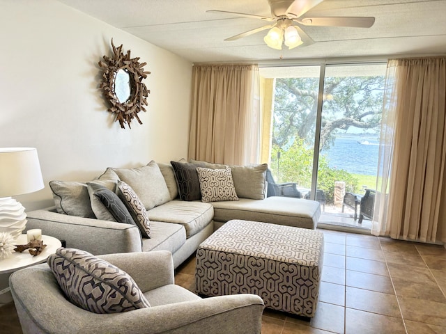 209 W Miracle Strip Pkwy Unit H 103, Mary Esther, FL 32569 - living room featuring plenty of natural light, tile patterned flooring, ceiling fan, a wall of windows, and a water view