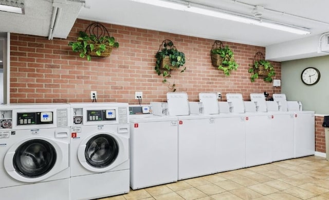 209 W Miracle Strip Pkwy Unit H 103, Mary Esther, FL 32569 - shared laundry with washer and clothes dryer, brick wall, and light tile patterned floors