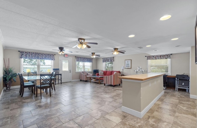 209 W Miracle Strip Pkwy Unit H 103, Mary Esther, FL 32569 - kitchen with baseboards, ceiling fan, wood counters, and recessed lighting