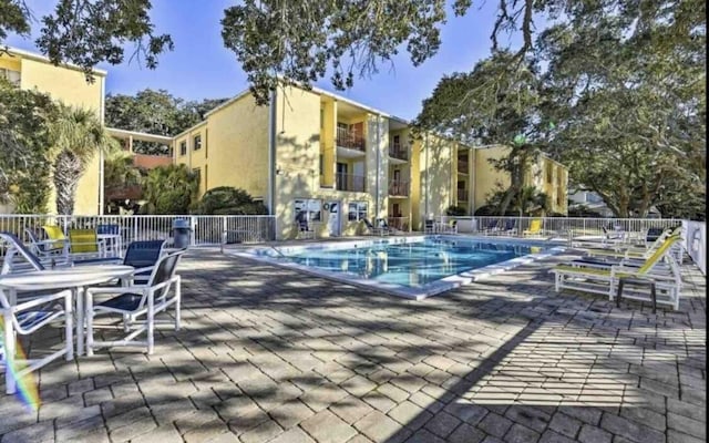 209 W Miracle Strip Pkwy Unit H 103, Mary Esther, FL 32569 - community pool featuring a patio area