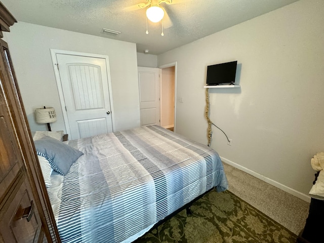 629 Earl Godwin Rd, Freeport, FL 32439 - carpeted bedroom with ceiling fan, a textured ceiling, and a closet