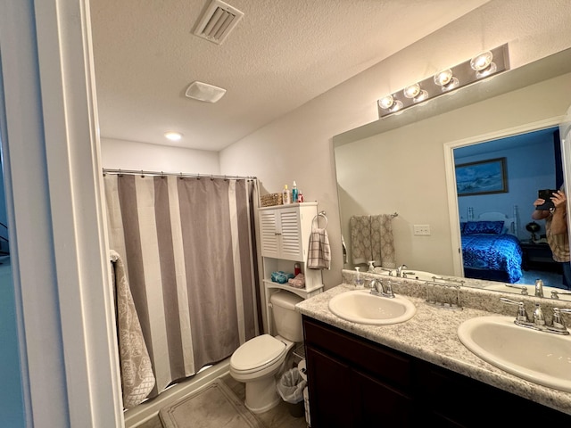 629 Earl Godwin Rd, Freeport, FL 32439 - ensuite bathroom featuring double vanity, a stall shower, a textured ceiling, and tile patterned flooring
