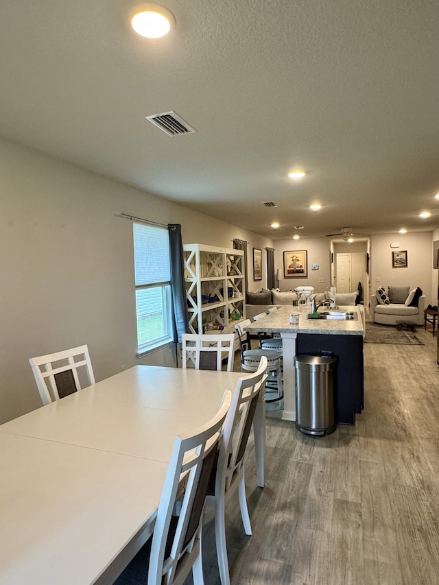 629 Earl Godwin Rd, Freeport, FL 32439 - dining area featuring wood finished floors, recessed lighting, and a textured ceiling