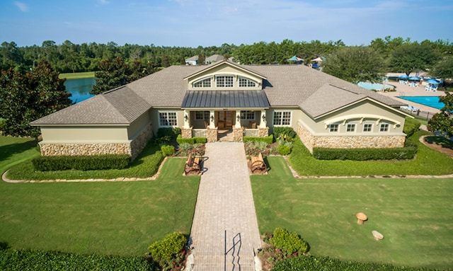 629 Earl Godwin Rd, Freeport, FL 32439 - view of front of house with stone siding, a front yard, and a porch