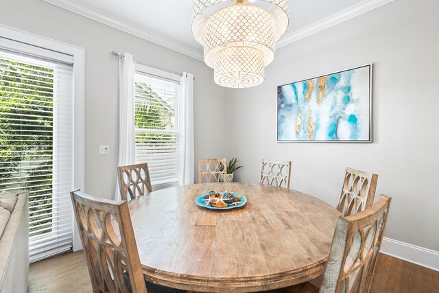 2350 W County Highway 30a Unit 2, Santa Rosa Beach, FL 32459 - dining area with wood finished floors, a chandelier, crown molding, and baseboards
