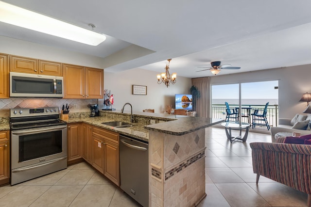 866 Santa Rosa Blvd Unit 302, Fort Walton Beach, FL 32548 - kitchen featuring stainless steel appliances, open floor plan, light tile patterned flooring, and decorative backsplash